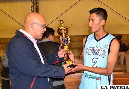 Celmar Alanes, capitán de CAN, recibe el trofeo de campeón