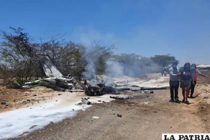 Residentes pasan junto al lugar donde se estrelló una avioneta /Foto AP