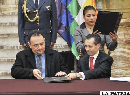 Ministro de Planificación del Desarrollo, René Orellana (izq.), y el vicepresidente del BM, Jorge Familiar (der.), durante la firma del convenio en Palacio de Gobierno
