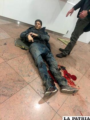 Un hombre herido espera por asistencia médica en el aeropuerto de Bruselas /infobae.com