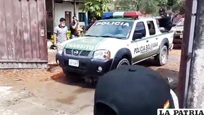El momento que sale un vehículo policial de la casa con los cuerpos de las víctimas /Erbol
