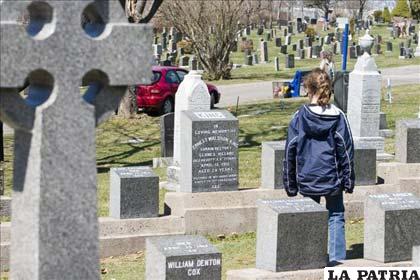 Una turista contempla una de las 121 tumbas de víctimas del Titanic, en el cementerio de Fairview Lawn de Halifax (Canadá)