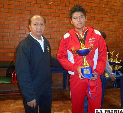 Alconini entrega el trofeo de campeón a Michael Omoya de San Martín