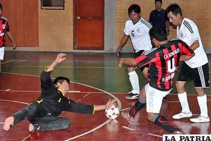 Rocabado, de Morales Moralitos, se esfuerza para detener el balón ante el ataque de Montaño, de Tomás Barrón