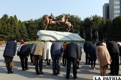 Varias personas se inclinan en señal de respeto frente a las estatuas de los difuntos líderes norcoreanos, Kim Il Sung y Kim Jong Il /AP Foto/Jon Chol Jin