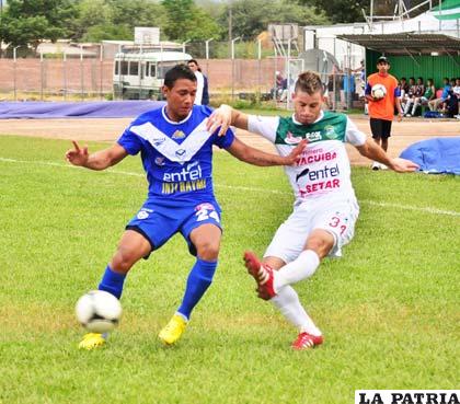 Paúl Burton y Luis Guevara disputan el balón