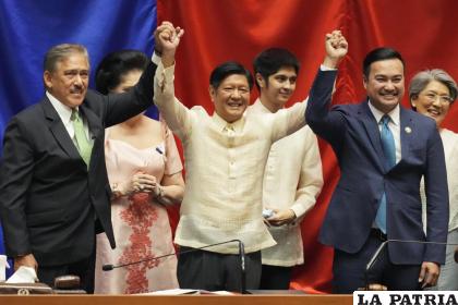 Ferdinand ‘Bong” Marcos Jr. (al centro) levanta las manos con el presidente del Senado, y el presidente de la cámara baja /AP Foto /Aaron Favila