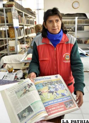 Maruja Aguilar mostrando los empastados que fueron donados a su biblioteca