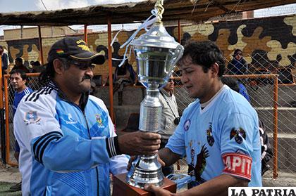 Antenor Pérez recibe el trofeo de campeón