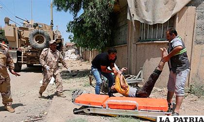 Fuerzas iraquíes levantan el cuerpo de una de las personas asesinadas por el EI al intentar huir de Mosul