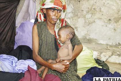 Madre somalí sostiene a su hijo malnutrido en Mogadiscio, Somalia