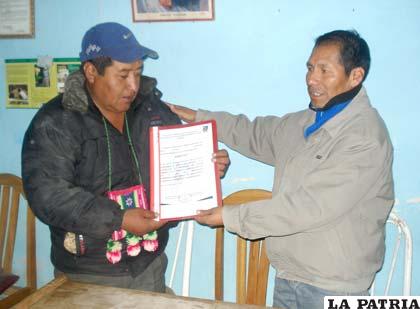 El corregidor de la zona Leoncio Condori (izq.), recibe el reconocimiento del Secretario General de la Gobernación de Oruro, Florencio Choque (der.)