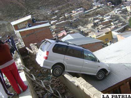 El vehículo prácticamente quedó colgado sobre el techo de la vivienda
