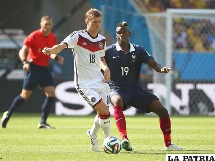 El alemán Kross y Pogba de Francia disputan el balón