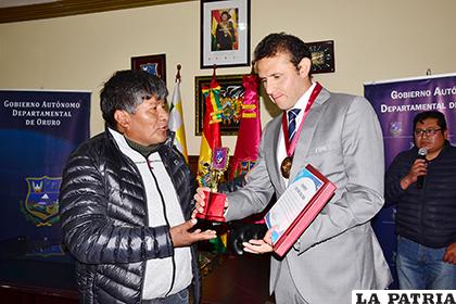 El gobernador Víctor Hugo Vásquez, hace la entrega de la distinción a Gery Vargas