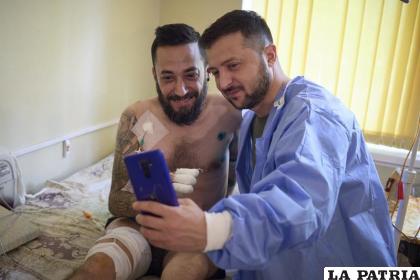El presidente de Ucrania, Volodymyr Zelenskyy (derecha), se toma una selfie con un soldado herido, en un hospital en Odesa /Oficina de prensa de las presidencia de Ucrania vía AP