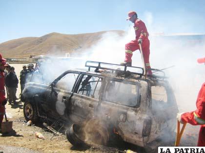 Un efectivo apaga el fuego desde el techo del motorizado