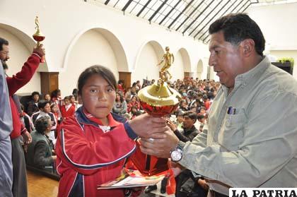 Wilfredo Tejerina entrega el trofeo a la representante del colegio Socavón