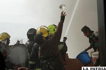 Un ciudadano arroja un globo con agua al lugar donde se encontraban las llamas /APG