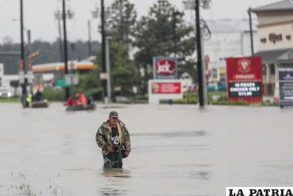 Un hombre camina por una calle inundada después del paso del huracán Harvey en Houston, Texas, Estados Unidos. / EFE