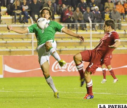 Marcelo Martins de Bolivia domina el balón ante la mirada de Aldo Corzo de Perú