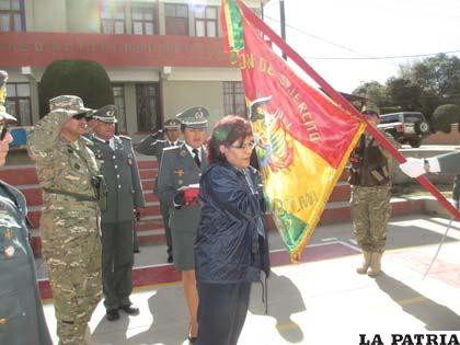 La presidente de la ANB, Marlene Ardaya, impone la condecoración al estandarte del Regimiento Camacho