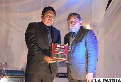 El rector Carlos Antezana hace entrega del premio al representante de Clínica Natividad