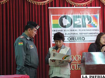 Presidenta del TEDO entrega resultados a un representante de las FF.AA.