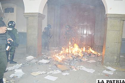 Policías antimotines apagaban el fuego generado en la puerta de la Gobernación