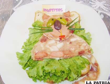 Plato elaborado en base a verduras y embutidos, formando la imagen de un gato