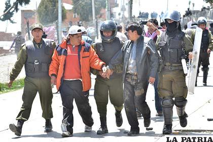 Universitarios al momento de ser detenidos por efectivos policiales