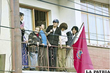 Vecinos se adhirieron a la marcha colocando la bandera rojo carmesí en sus balcones