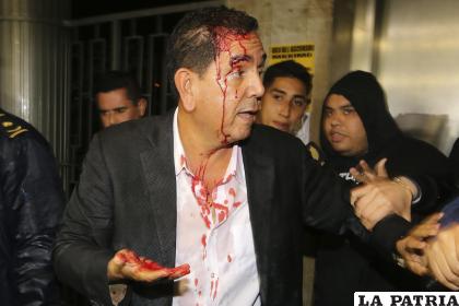 El diputado por el Partido Nacional Antonio Rivera es resguardado después de ser agredido por simpatizantes del partido gobernante /EFE