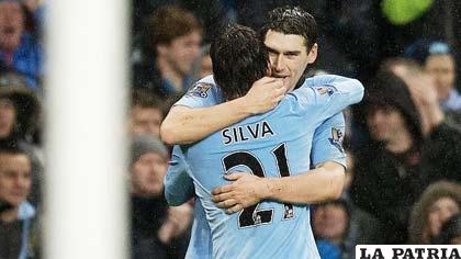 Gareth Barry y David Silva, celebran el gol del City