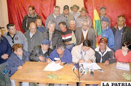 Los representantes de los jubilados y Gobierno firman el acuerdo que suspendió la marcha a La Paz