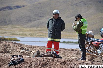 La víctima yace a los pies del bombero que lo sacó del agua